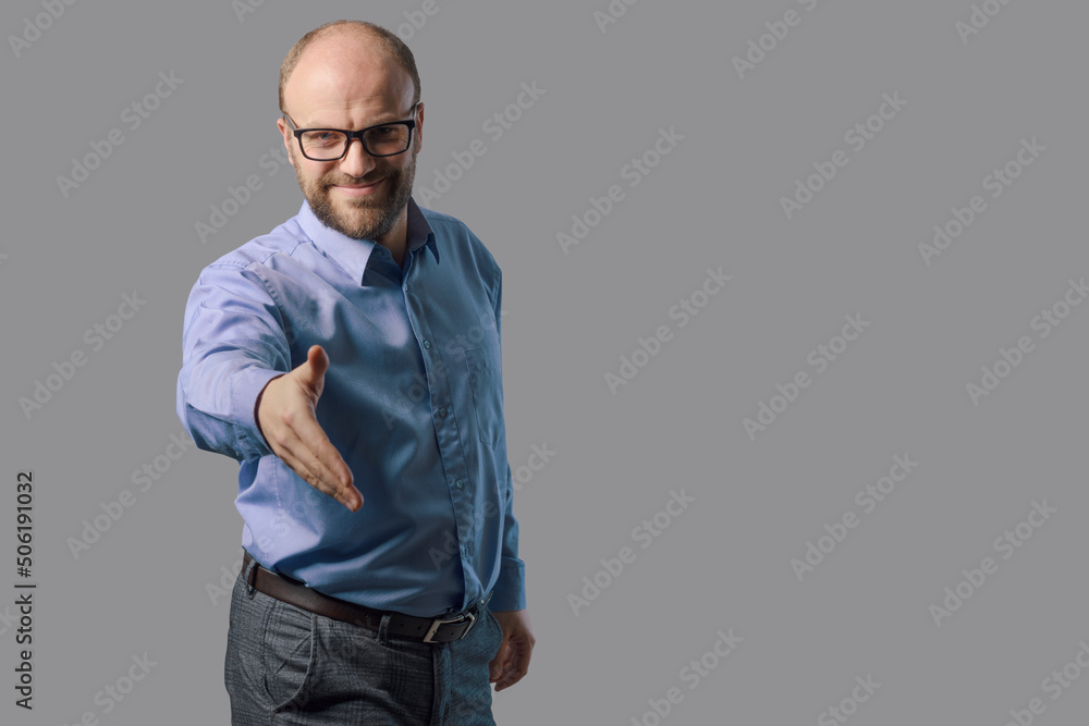 Smiling businessman giving a handshake Smiling businessman giving a handshake