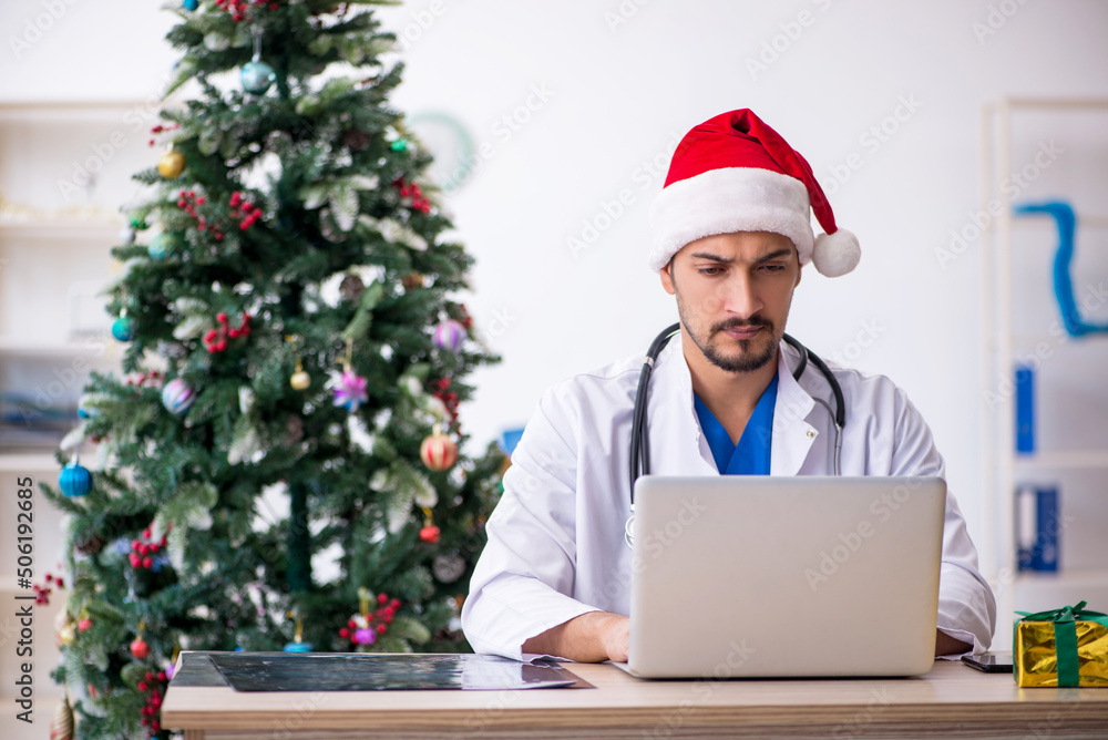 Young male doctor celebrating Christmas at the hospital Young male doctor celebrating Christmas at the hospital