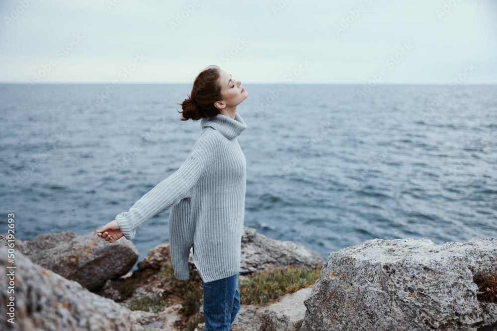 pretty woman beach tourism cloudy weather stone coast female relaxing back view