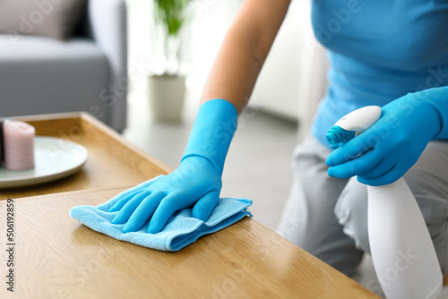 Woman cleaning a table at home