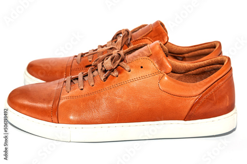 Men's youth leather shoes of brown color with a white sole on a white background.