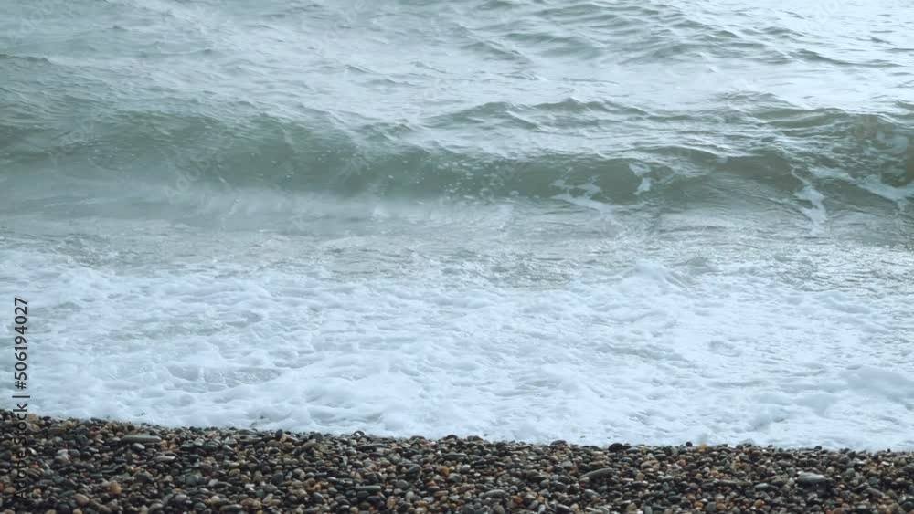 Sea waves on a pebble beach Sea waves on a pebble beach