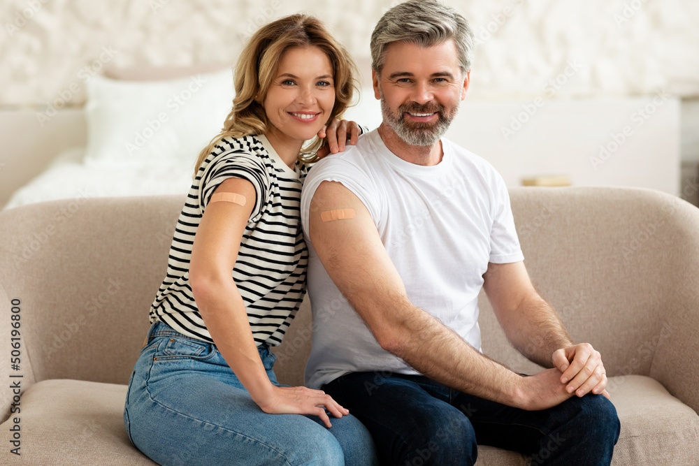 Vaccinated Husband And Wife Showing Arms With Plaster At Home Vaccinated Husband And Wife Showing Arms With Plaster At Home