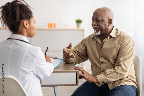 Black patient talking to doctor during appointment photo