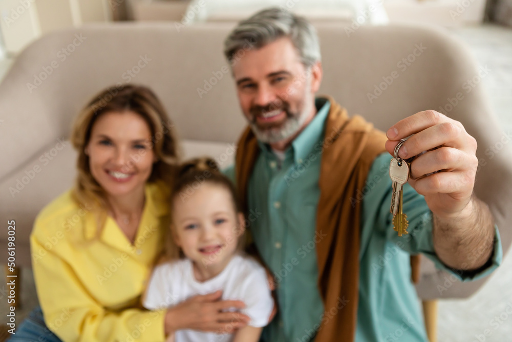 Cheerful Family Showing New House Keys To Camera At Home