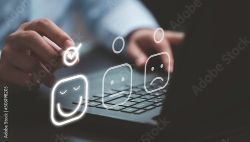 Businessman tick mark to select smiley face icon for client evaluation and customer satisfaction after use product and service concept.