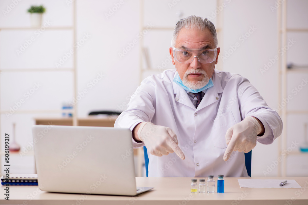 Old male chemist working in the lab during pandemic Old male chemist working in the lab during pandemic