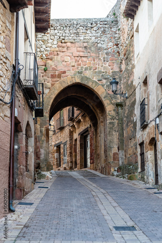 View of the historic town of Atienza with old stone houses and cobblestoned street. Archway