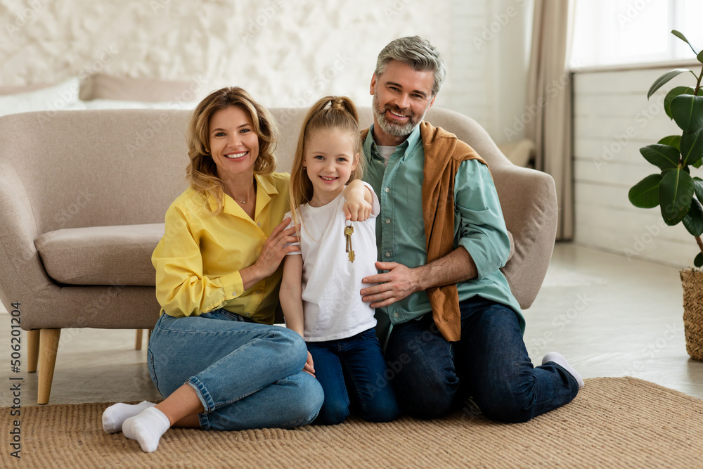 Happy Family Showing New House Key Smiling Sitting At Home Happy Family Showing New House Key Smiling Sitting At Home