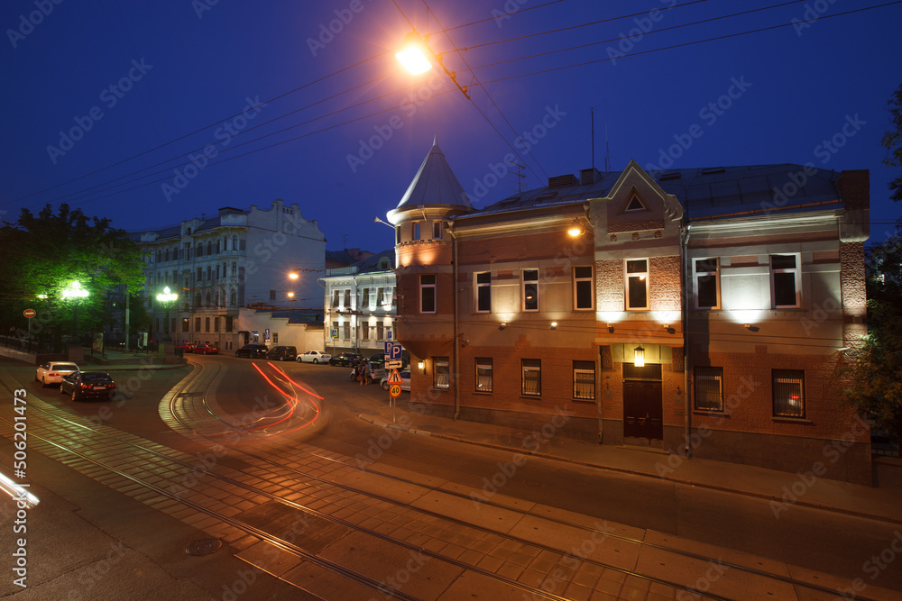 Fototapeta premium Moscow, Russia - July, 27 2014: Historical buildings in Moscow center at night. Mansion on Yauza boulevard. Tram rails and light traces on foreground.