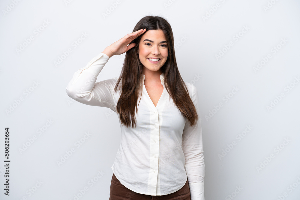 Young Brazilian woman isolated on white background saluting with hand with happy expression Young Brazilian woman isolated on white background saluting with hand with happy expression