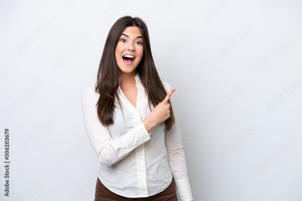 Young Brazilian woman isolated on white background surprised and pointing side