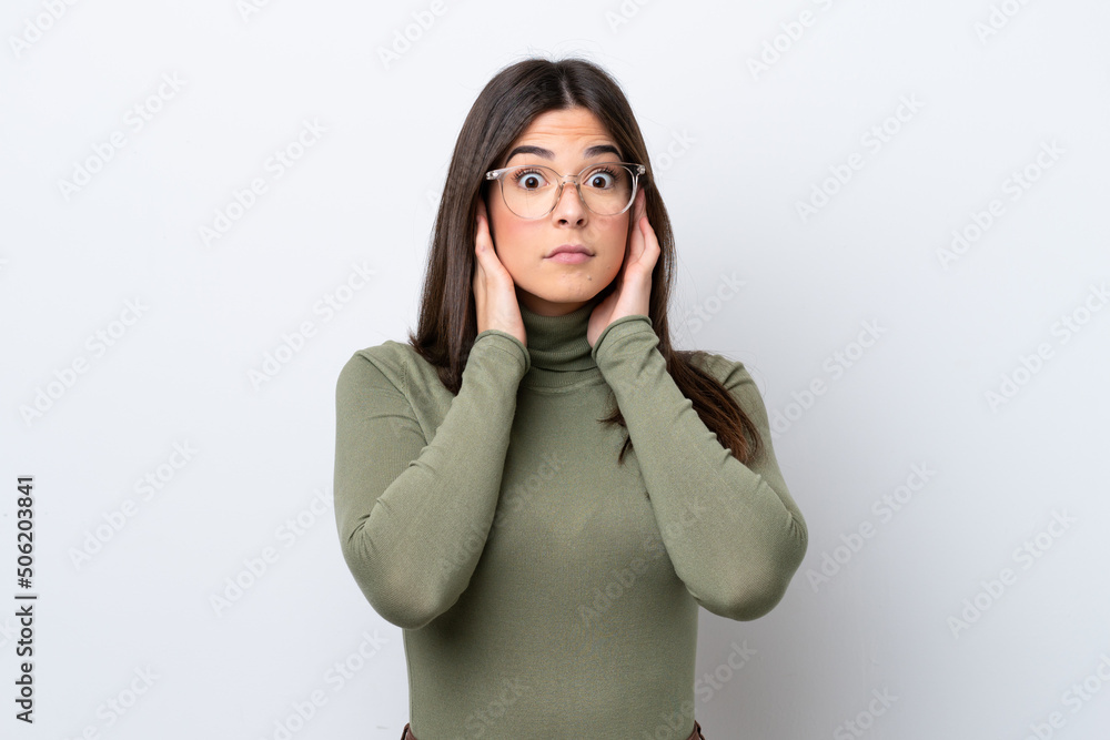 Young Brazilian woman isolated on white background frustrated and covering ears Young Brazilian woman isolated on white background frustrated and covering ears