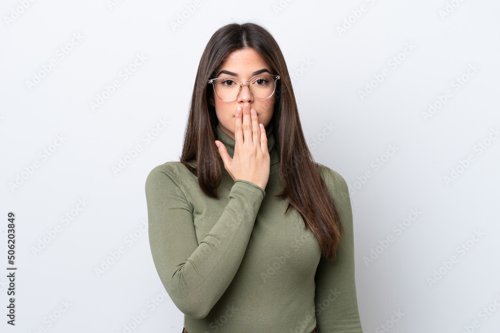 Young Brazilian woman isolated on white background covering mouth with hand Young Brazilian woman isolated on white background covering mouth with hand