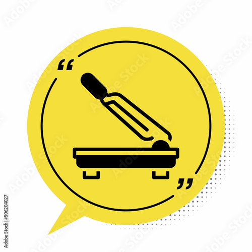 Black Paper cutter icon isolated on white background. Yellow speech bubble symbol. Vector