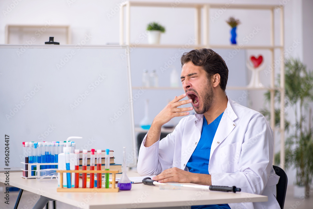 Fototapeta premium Young male chemist working at the lab