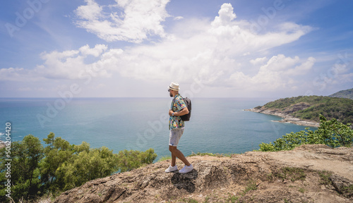 Young traveler man at summer holiday vacation with beautiful mountains and seascapes at background