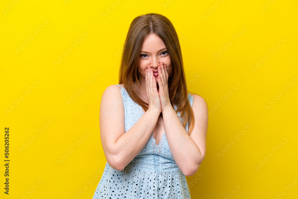 Young caucasian woman isolated on yellow background happy and smiling covering mouth with hands Young caucasian woman isolated on yellow background happy and smiling covering mouth with hands