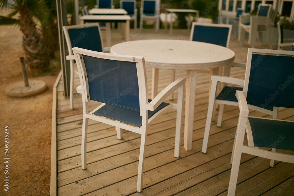 White-blue chairs on the coast in a restaurant. 