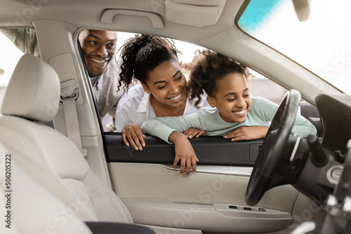 Cheerful Black Family Of Three Buying And Choosing New Car