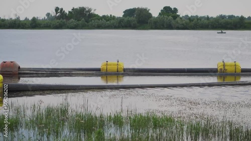 Pumping sand on the river. Water pump and pipes on the water