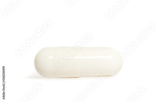 White capsule pill on white background
