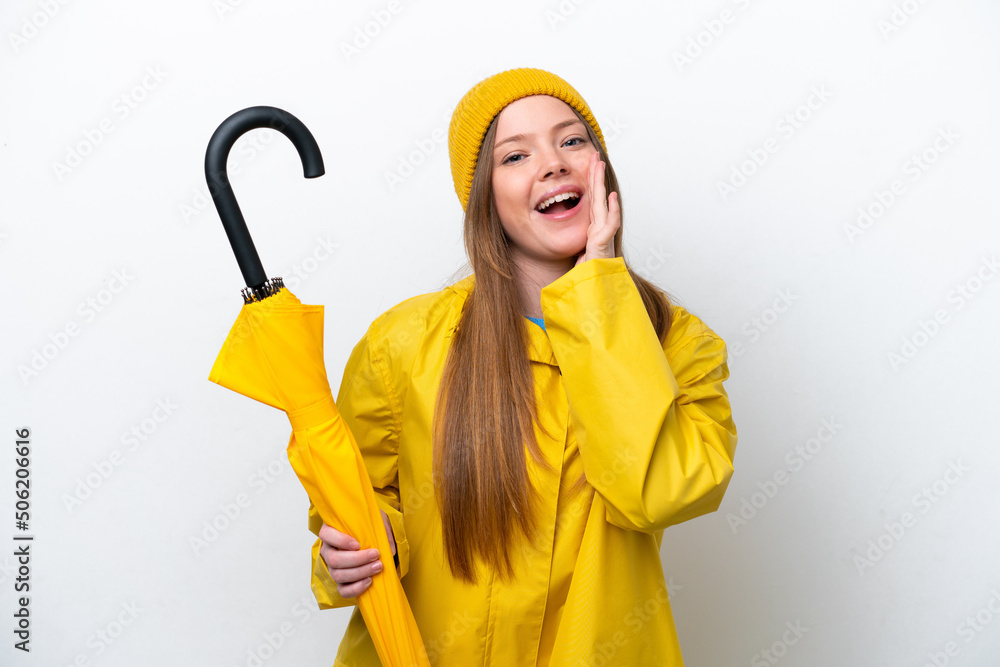 Young caucasian woman with rainproof coat and umbrella isolated on white background shouting with mouth wide open Young caucasian woman with rainproof coat and umbrella isolated on white background shouting with mouth wide open