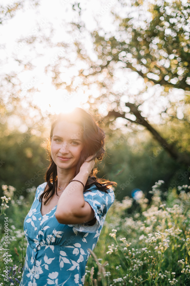 Portrait of beautiful European woman smiling and looking away at park during sunset. Outdoor portrait of a smiling girl. Happy cheerful girl in blue silk dress
Portrait of beautiful European woman smiling and looking away at park during sunset. Outdoor portrait of a smiling girl. Happy cheerful girl in blue silk dress