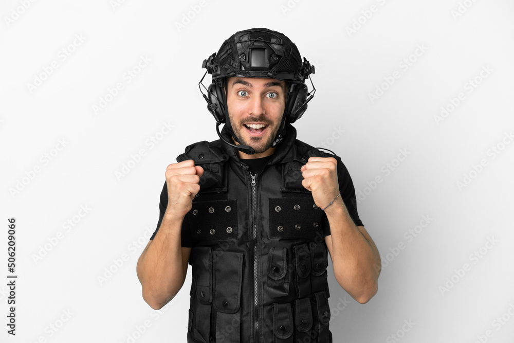 Young caucasian swat isolated on white background celebrating a victory in winner position Young caucasian swat isolated on white background celebrating a victory in winner position
