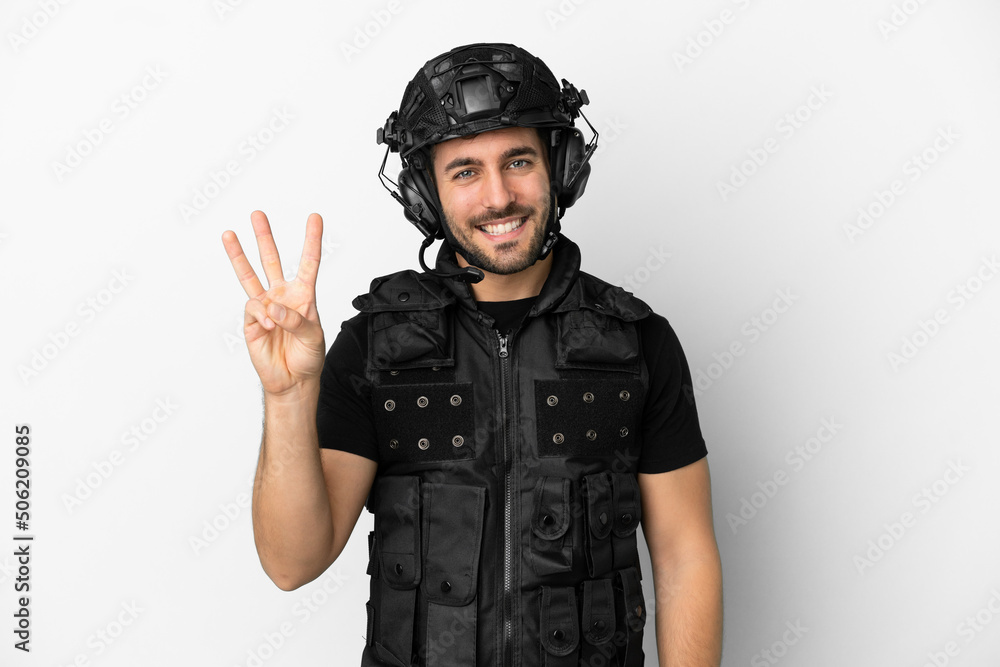 Young caucasian swat isolated on white background happy and counting three with fingers Young caucasian swat isolated on white background happy and counting three with fingers