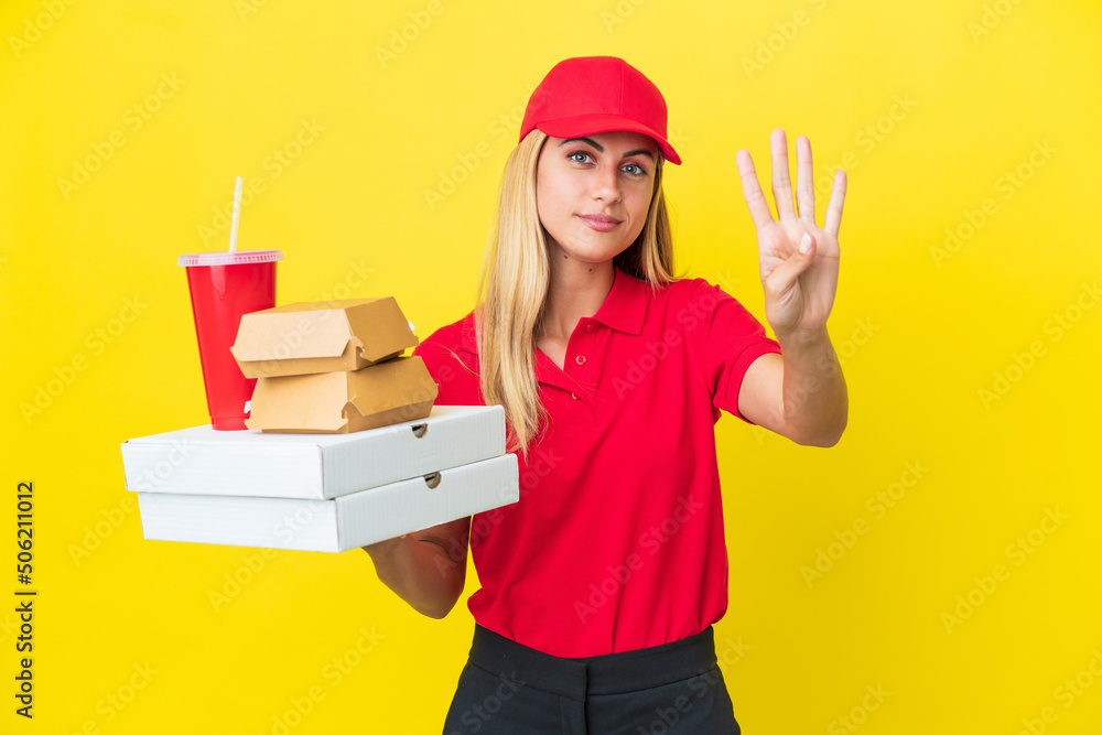 Delivery Uruguayan woman holding fast food isolated on yellow background happy and counting four with fingers Delivery Uruguayan woman holding fast food isolated on yellow background happy and counting four with fingers