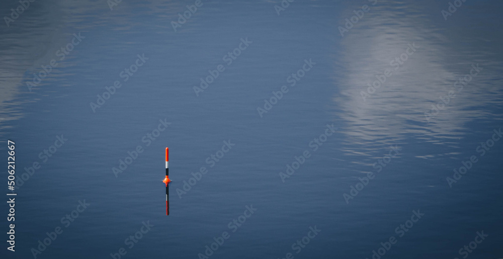 
Float for fishing on calm water with space for text, fish bite alarm, rest and tranquility