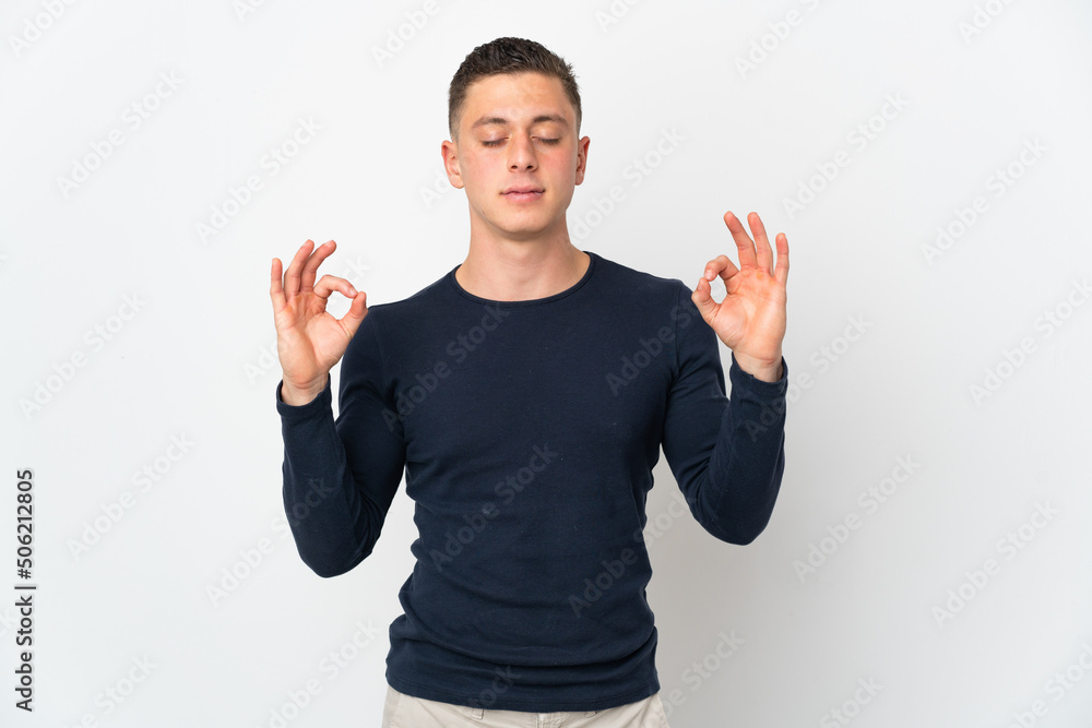 Young caucasian man isolated on white background in zen pose Young caucasian man isolated on white background in zen pose