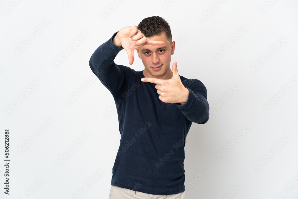 Young caucasian man isolated on white background focusing face. Framing symbol Young caucasian man isolated on white background focusing face. Framing symbol