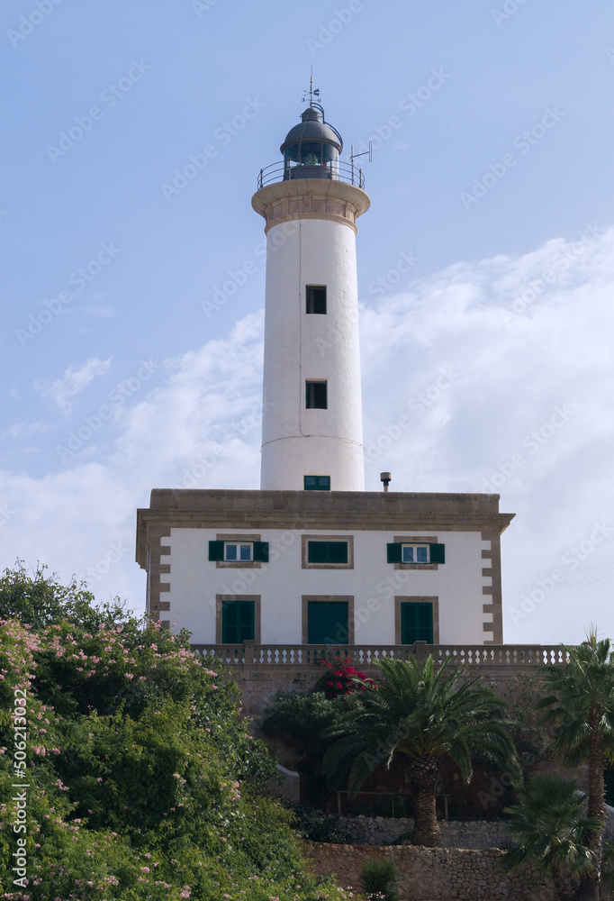 Lighthouse in the port of Ibiza. Beautiful lighthouse painted white on a sunny day. View of the Ibiza lighthouse from below. 