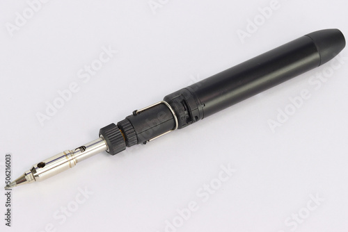 Electric soldering iron close-up on a white background.