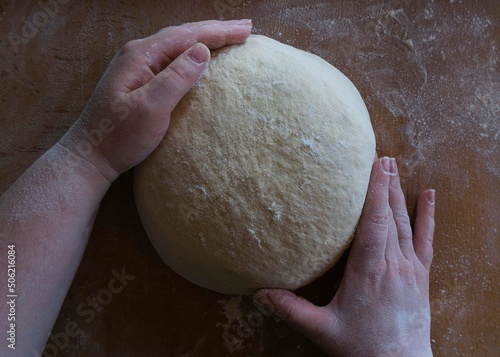 Women's hands knead the dough 2