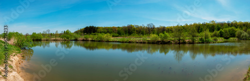 Fototapeta Naklejka Na Ścianę i Meble -  Panoramic view of a calm lake on a sunny summer day