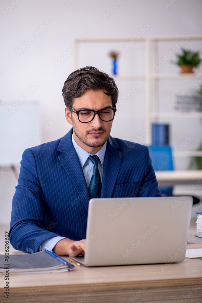 Young businessman employee and too much work in the office Young businessman employee and too much work in the office