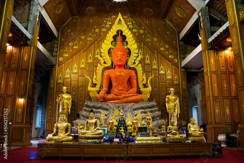 Beauty orange buddha statue for thai people travel visit respect praying blessing holy in Wat Charoen Rat Bamrung or Nong Pong Nok temple at Kamphaeng Saen on May 4 , 2022 in Nakhon Pathom, Thailand
