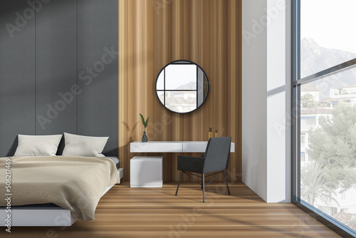 Modern hotel studio interior with bed, dressing table and panoramic window Fototapeta