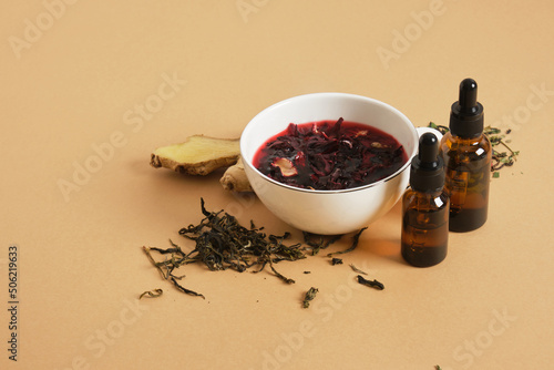 hibiscus brewed tea in a cup and two dropper bottles with pipettes, drink additives, anti-stress drink