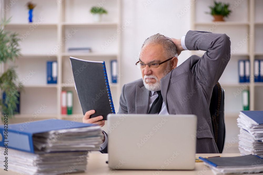 Old male employee and too much work in the office Old male employee and too much work in the office