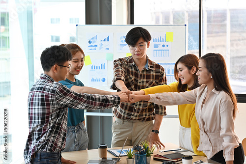 Картината върху платно A group of Asian business team is fist bump for strengthen a team for company campaigns