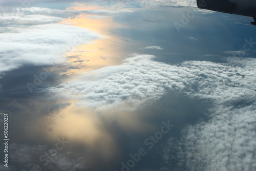 beautiful view from the plane window. Flying over the clouds and the sea.