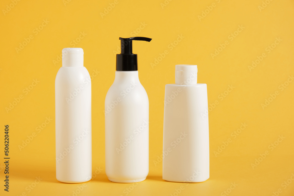 Blank mockup cosmetic packages on yellow background Blank mockup cosmetic packages on yellow background