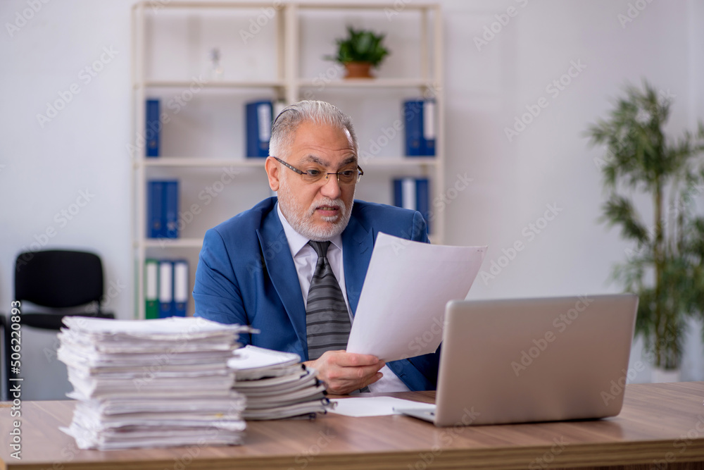 Old male employee and too much work in the office Old male employee and too much work in the office
