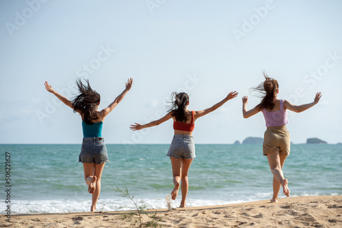 Asian happy friends is having fun at beach .