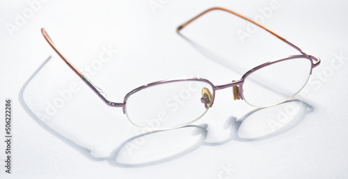 longsighted prescription glasses with shadow arranging on white background
