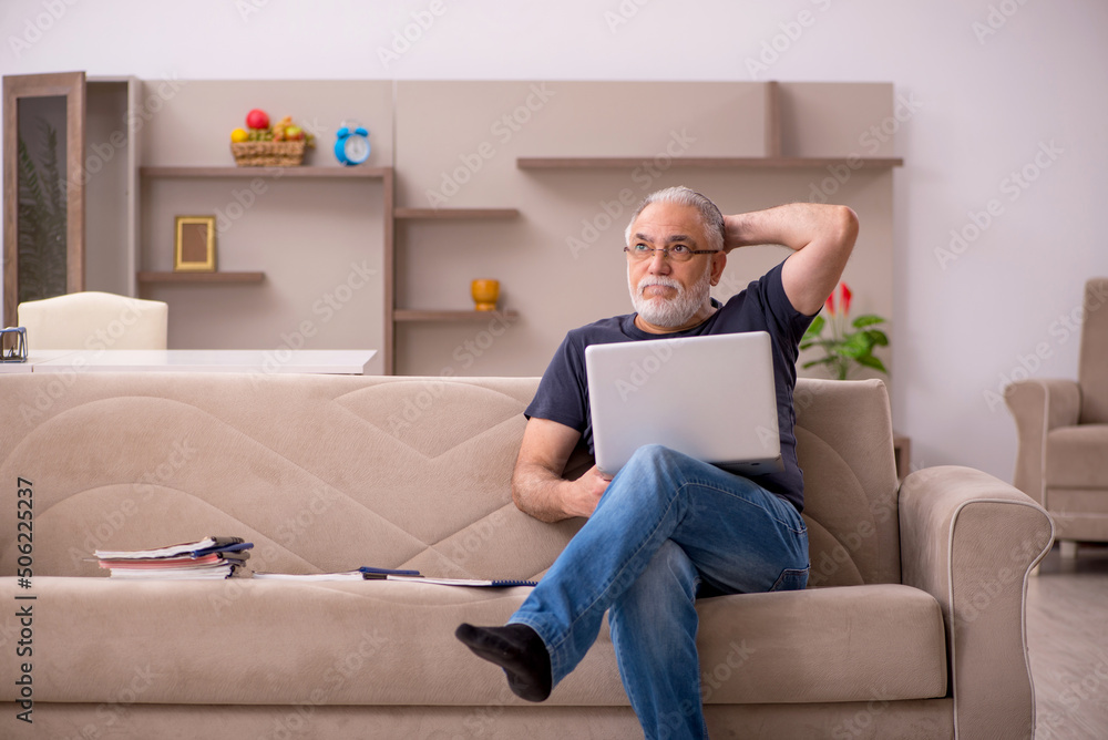 Old male employee working from home during pandemic Old male employee working from home during pandemic